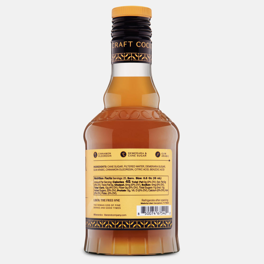 Cinnamon syrup bottle on kitchen shelf with label.