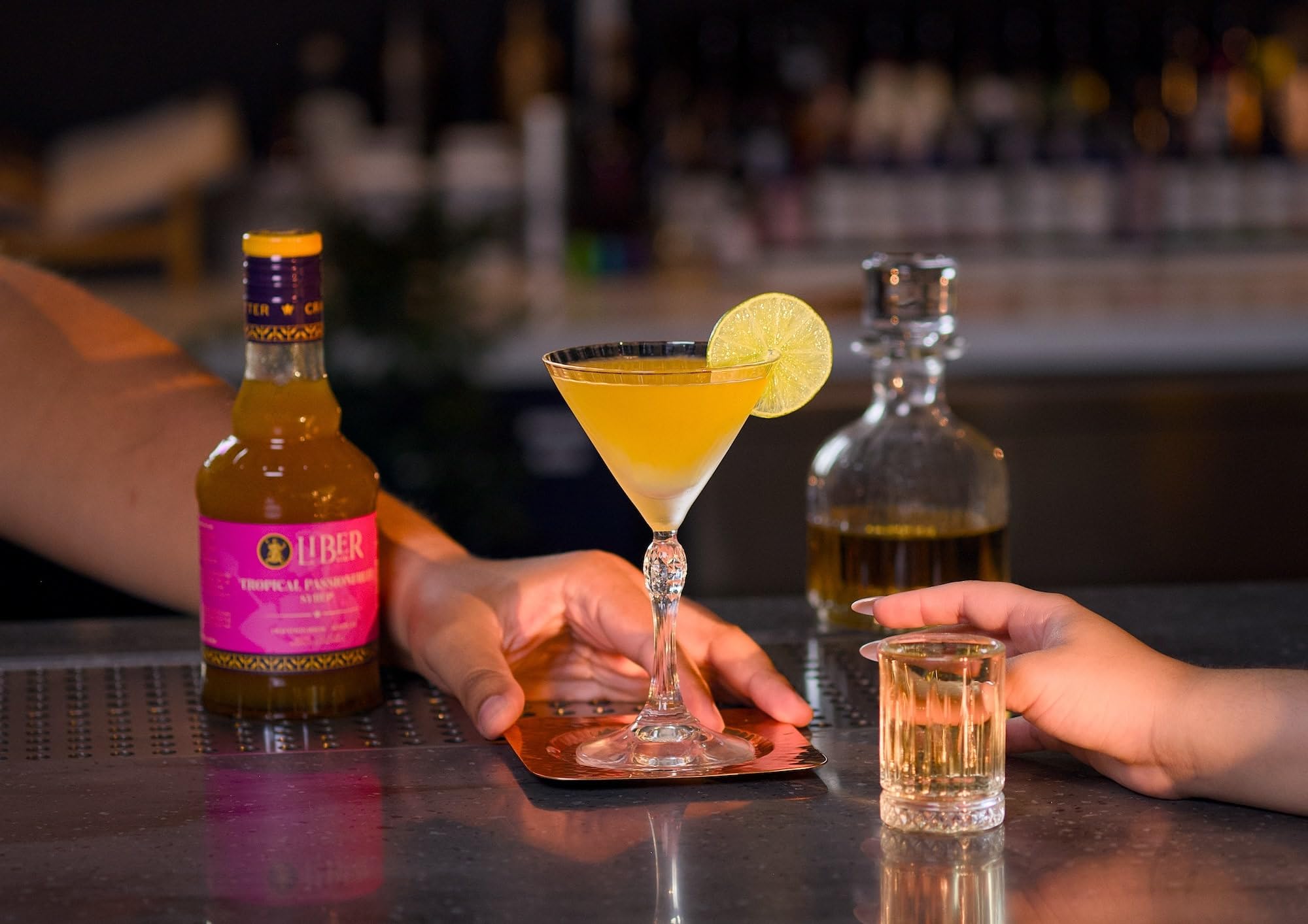 Liber & Co. Tropical Passion Fruit Syrup label emphasizing 50% real juice for richer drinks.