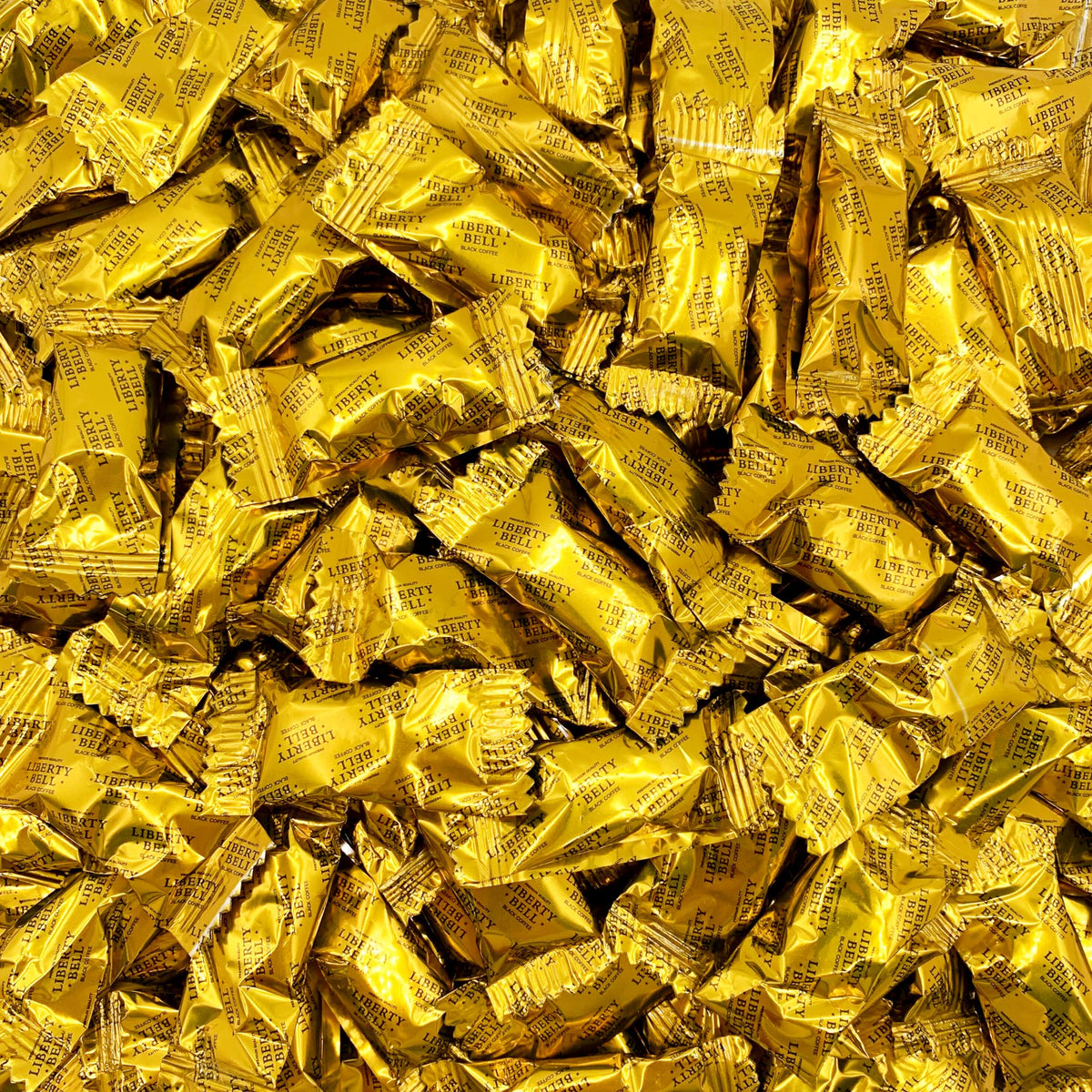 LIBERTY BELL Brazilian coffee candy in a 1 lb bag on a desk for office use.