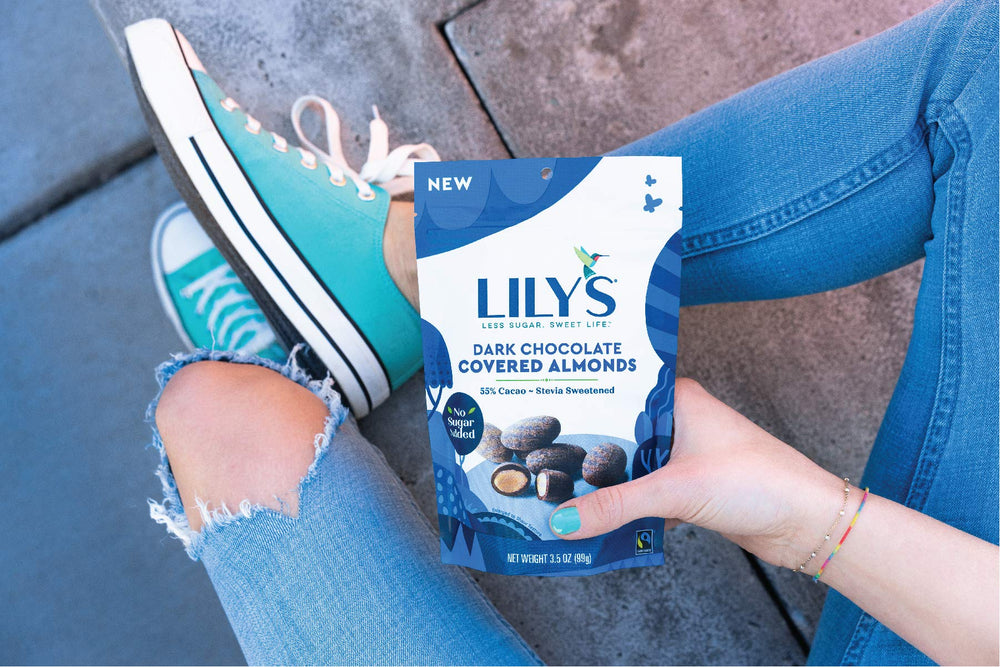 Lily's chocolate almonds on a festive tray, highlighting fair trade and gluten-free ingredients.