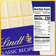 Lindt CLASSIC RECIPE White Chocolate Bar sliced into bite-sized pieces for sharing.