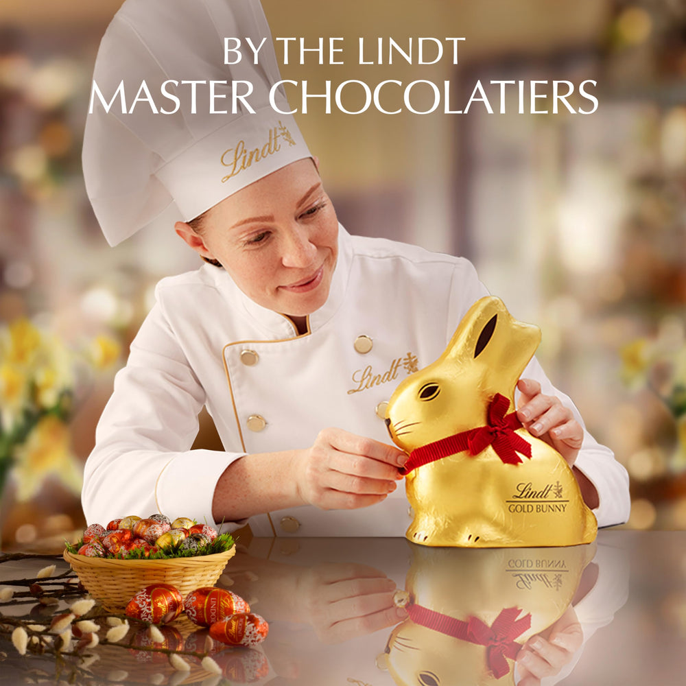 Lindt GOLD BUNNY packaging on a decorative table, enhances holiday decor.