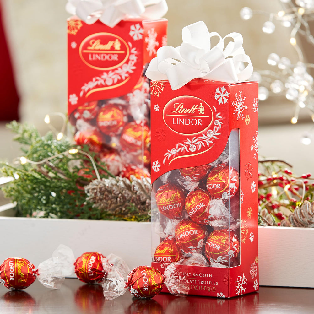 Lindt Lindor Milk Chocolate Truffles in a red holiday box ready to gift