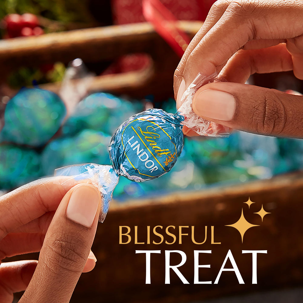 Lindt Lindor Milk Chocolate Salted Caramel bite shot highlighting creamy texture.