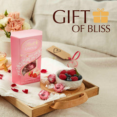 Lindt Lindor Strawberry & Cream filling close-up, silky texture ideal for sharing.