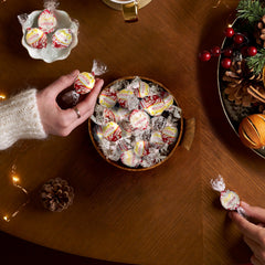 Lindt LINDOR truffles close-up shell and filling highlights delicate peppermint centers.