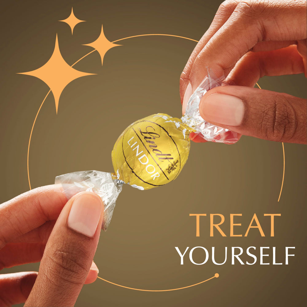 Lindt LINDOR white chocolate truffles close-up, bright notes for after-dinner treats.