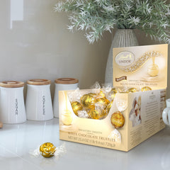 Lindt LINDOR White Truffles shell close-up shows creamy white chocolate with a melting center.