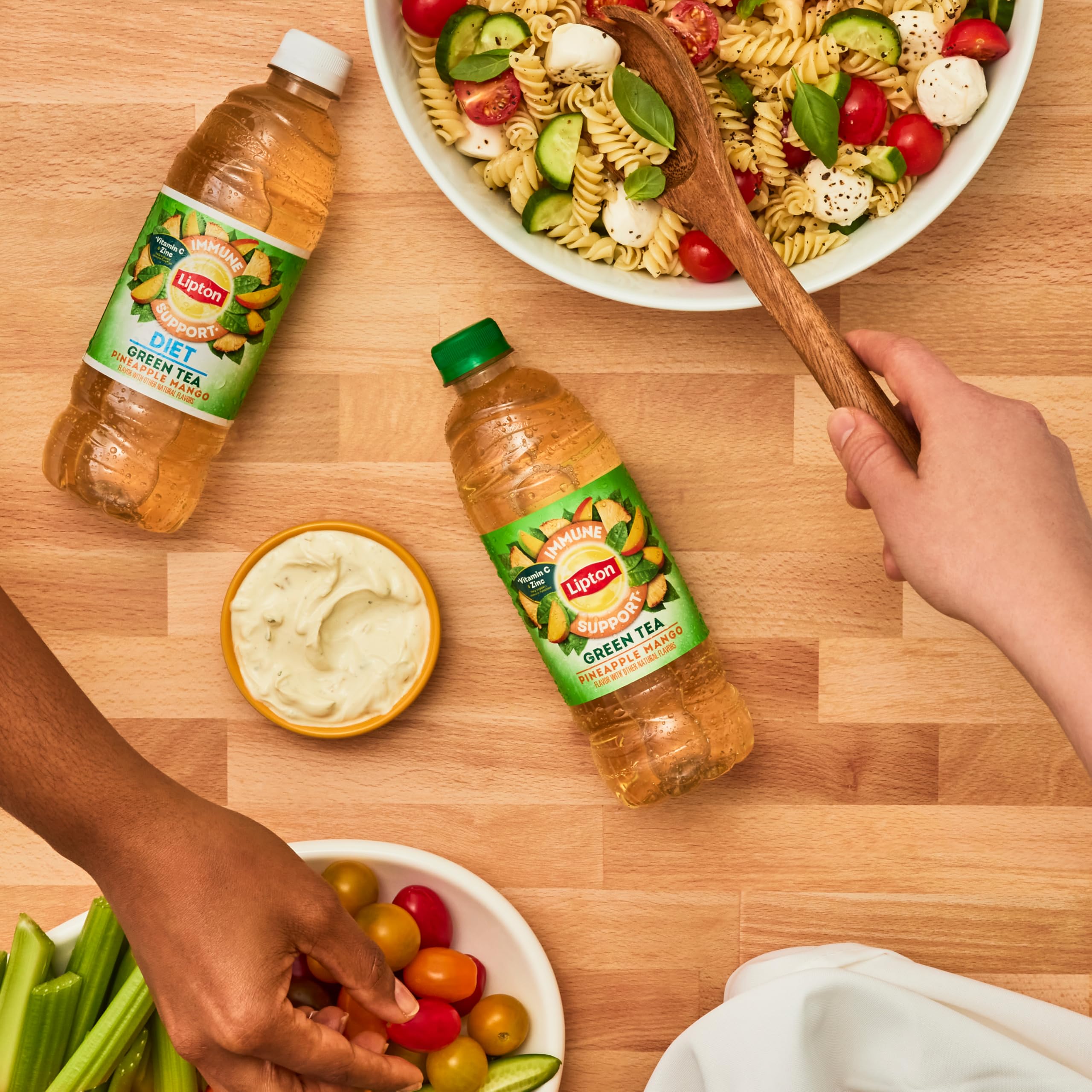 Lipton Immune Support Pineapple Mango bottle in tropical setting ready to enjoy anytime.