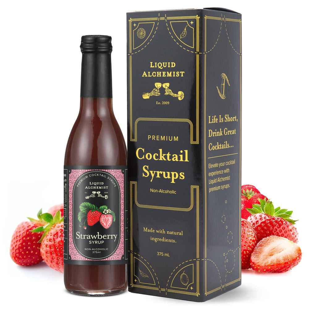 Liquid Alchemist strawberry syrup bottle being poured into a glass for cocktails