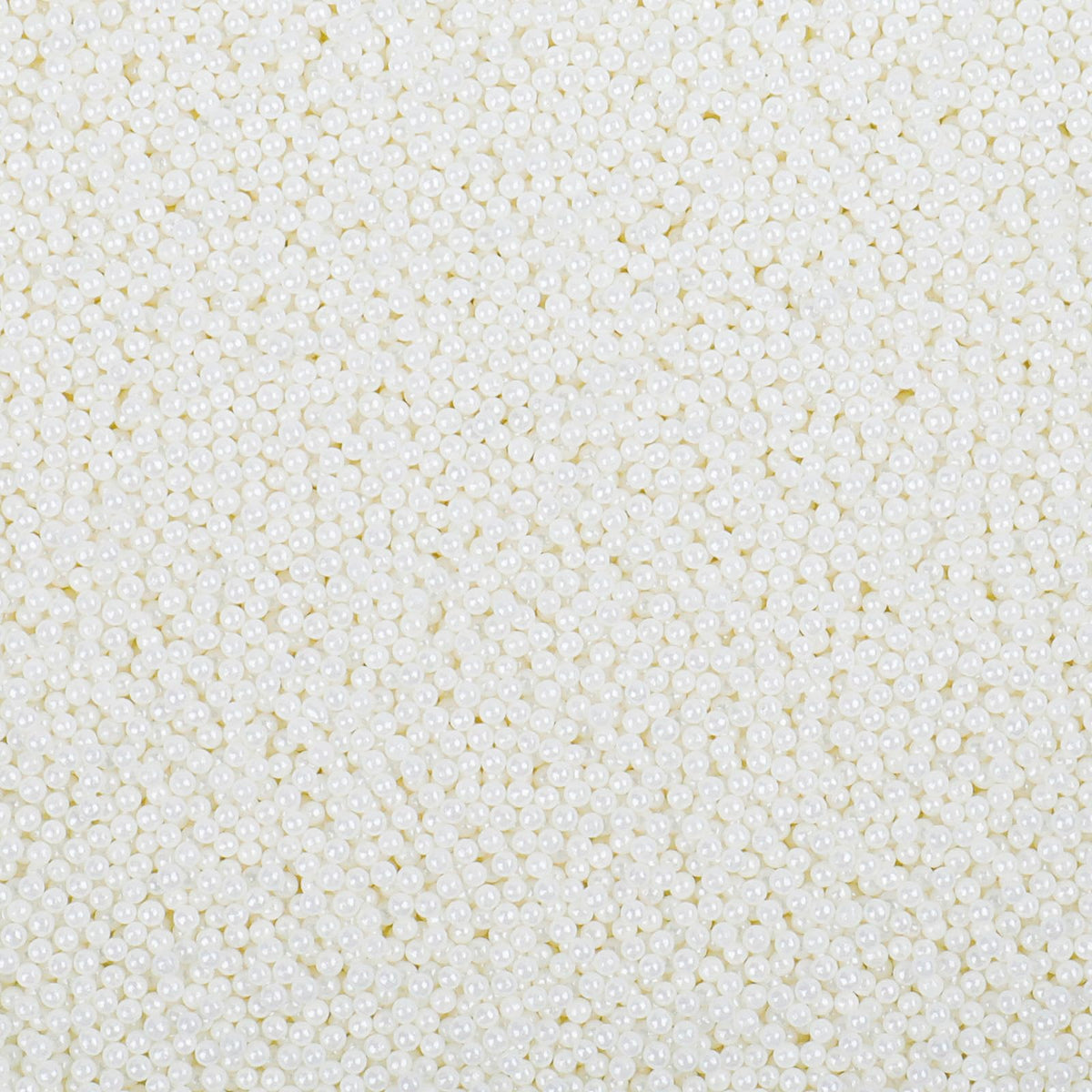 LittleStar white 2mm nonpareils sprinkled on frosted cake for a festive finish