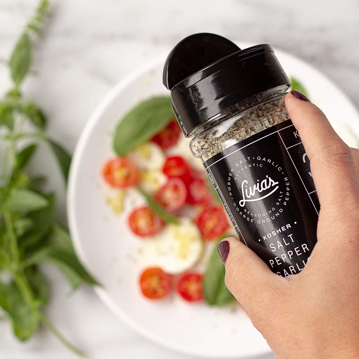 Close-up of Livia's Salt Pepper Garlic Seasoning showing kosher salt and garlic granules.