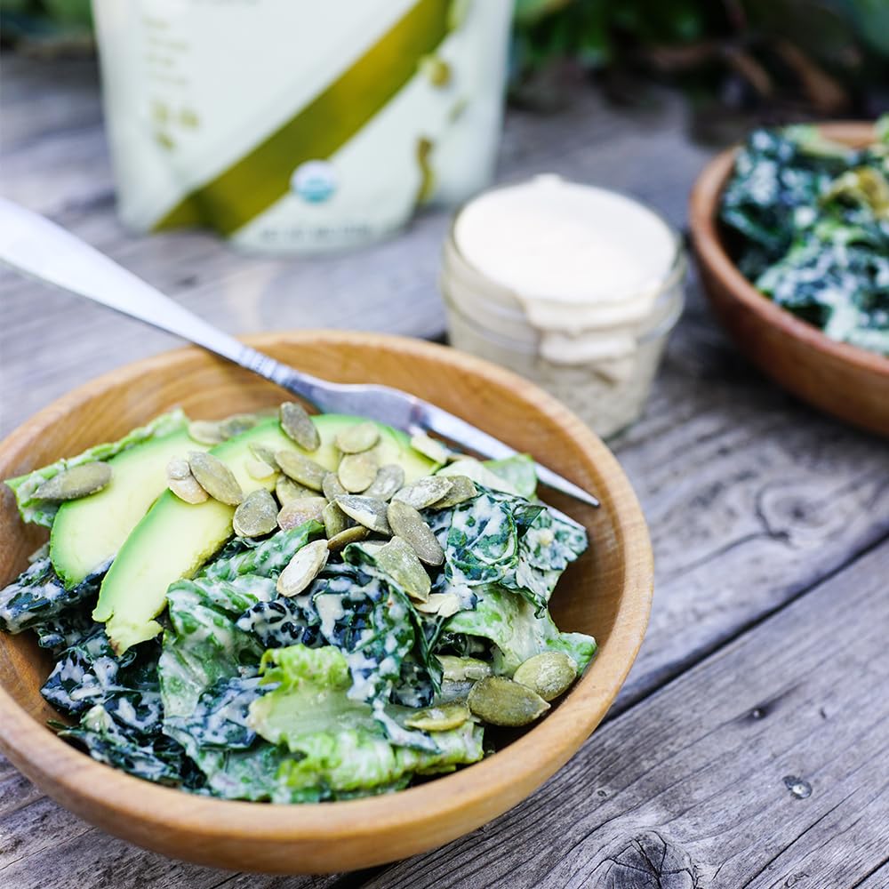 Living Intentions Sprouted Pumpkin Seeds Salted on a rustic surface, emphasizing natural energy.