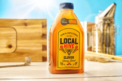 Pouring Local Hive Clover Honey into tea elevates natural sweetness.