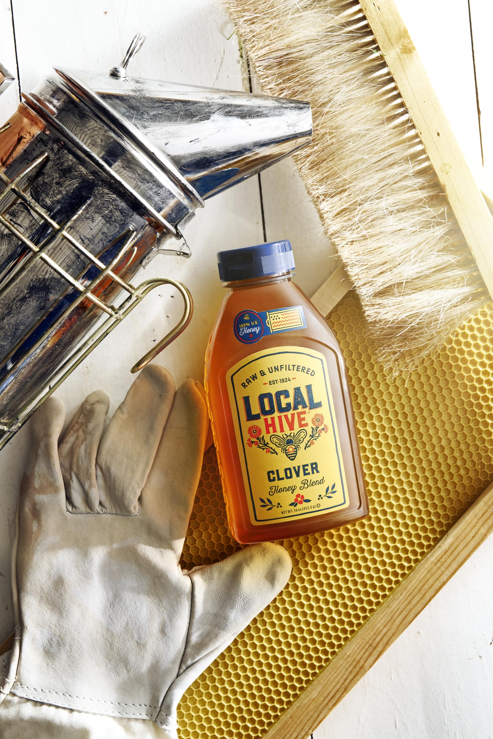 Local Hive Clover Honey label detail highlights 100% raw and unfiltered quality.