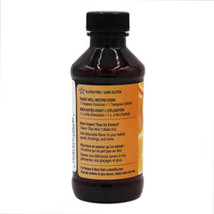 Pouring LorAnn Orange Bakery Emulsion from bottle into bowl for zest-like flavor.