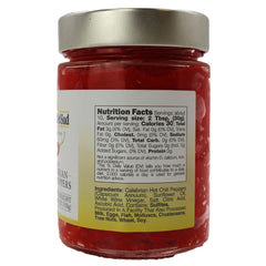 Spoon dipping into L'Oro Del Sud paste shows rich color and mild heat.