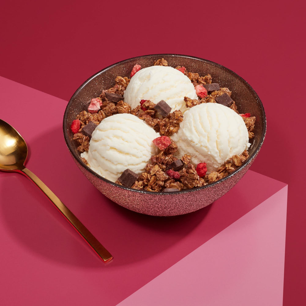 Love Crunch granola ingredient closeup reveals oats and chocolate bits.