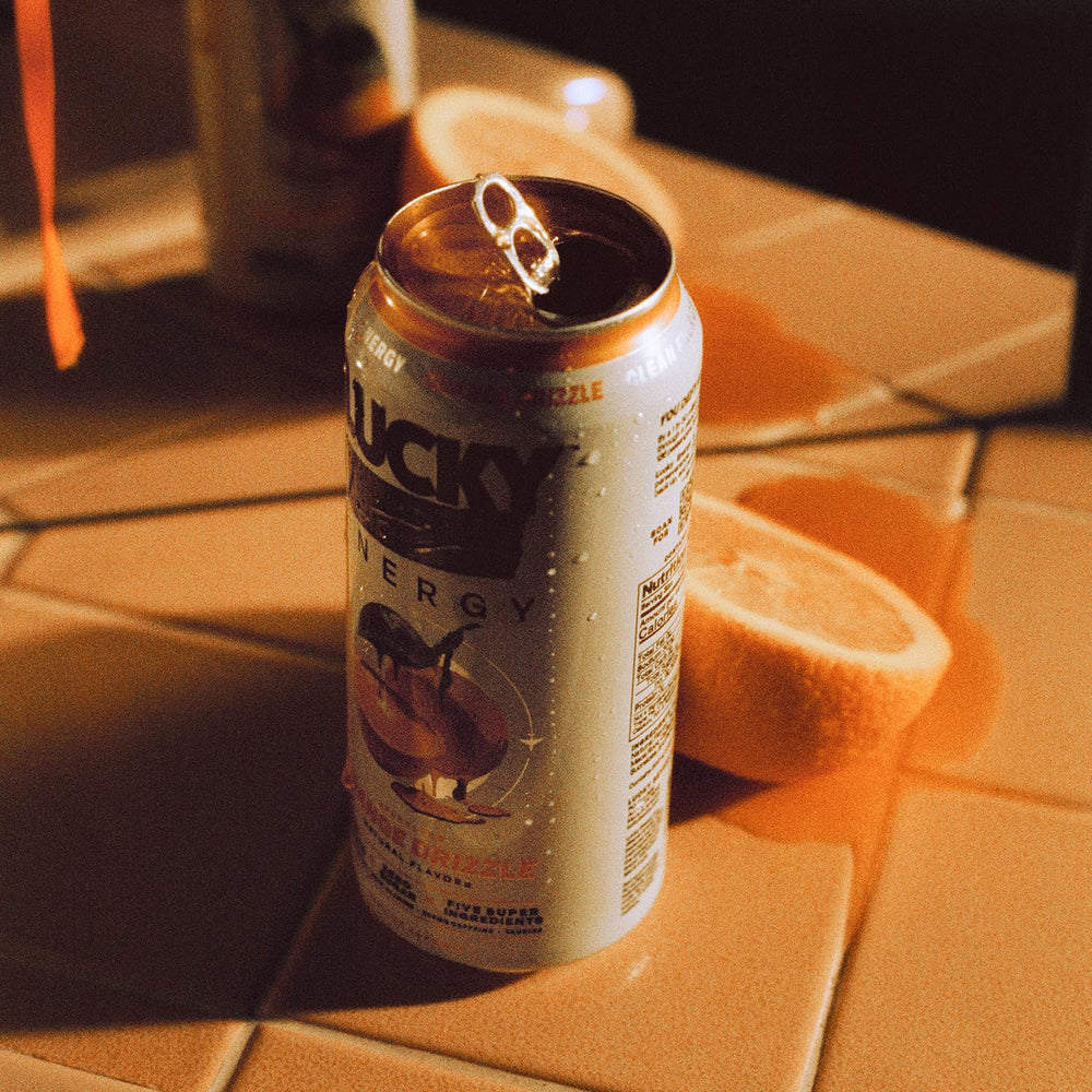 Lucky Energy Orange Drizzle 12-pack display for convenient energy on demand.