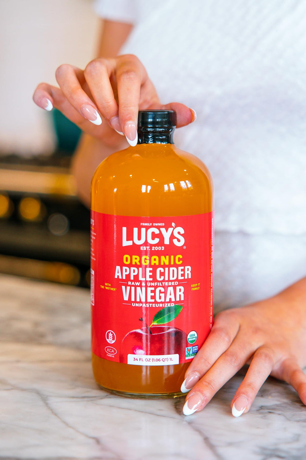Lucy’s Organic Apple Cider Vinegar label emphasizes organic, unfiltered quality.