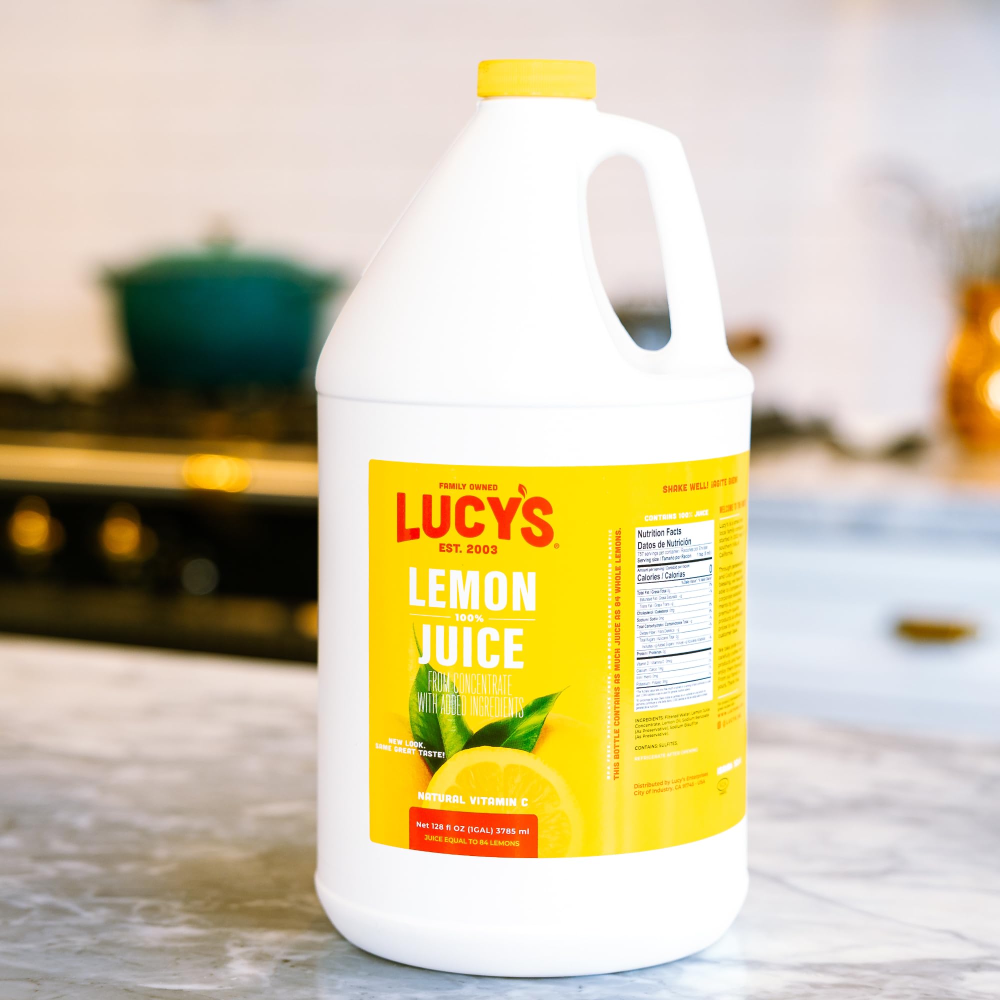 Lucys Lemon Juice lemonade-ready bottle beside a glass implies quick beverage prep.