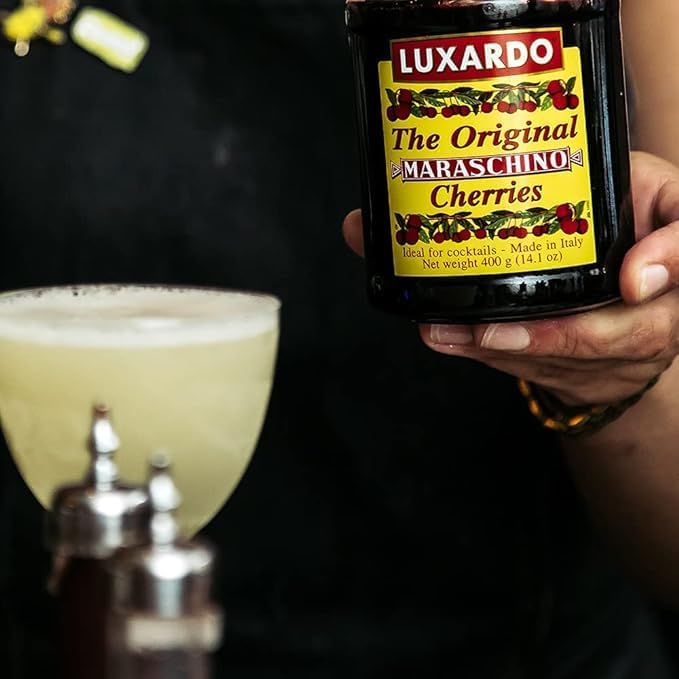 Old Fashioned setup with Luxardo cherries as a premium garnish.