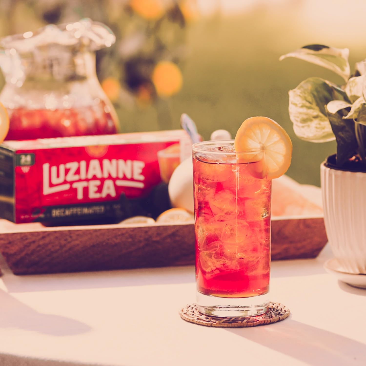 Luzianne iced tea poured with fresh mint and raspberries for flavor twist.