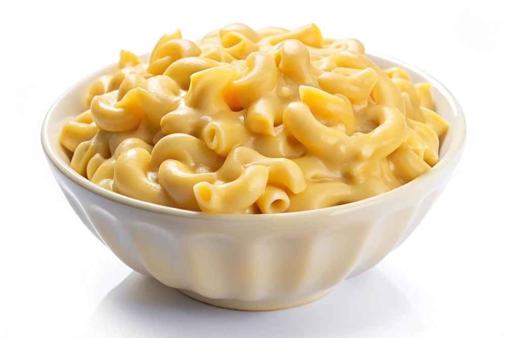 Mac Yourself serving spoon beside prepared macaroni and cheese.