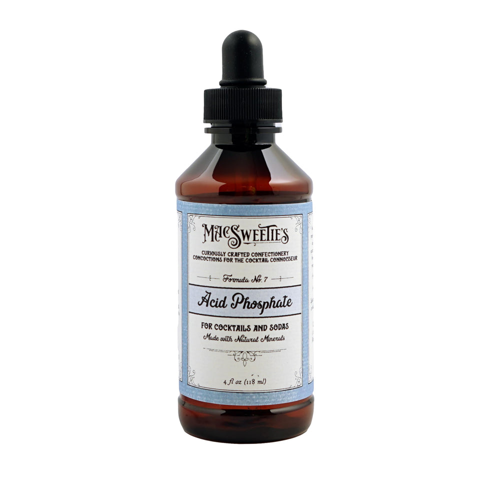 MacSweetie's Acid Phosphate bottle shown on bar, adds tangy depth to cocktails and sodas.