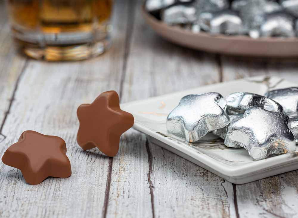 Madelaine Silver Stars milk chocolate candies wrapped in silver foil for gifts