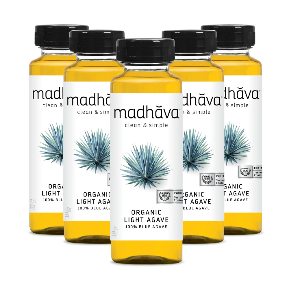 Madhava Organic Light Agave Nectar bottle on counter, ideal natural sweetener for beverages.