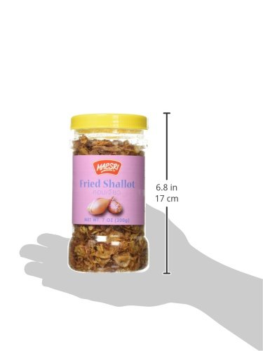 Maesri fried shallots on dish, enhances flavor with savory crunch.