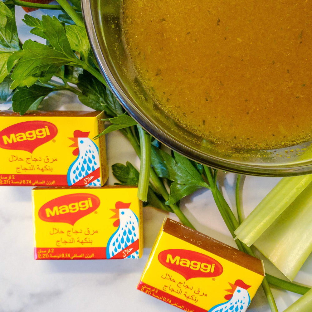 Maggi Chicken Coullion halal broth simmer in pot close-up.