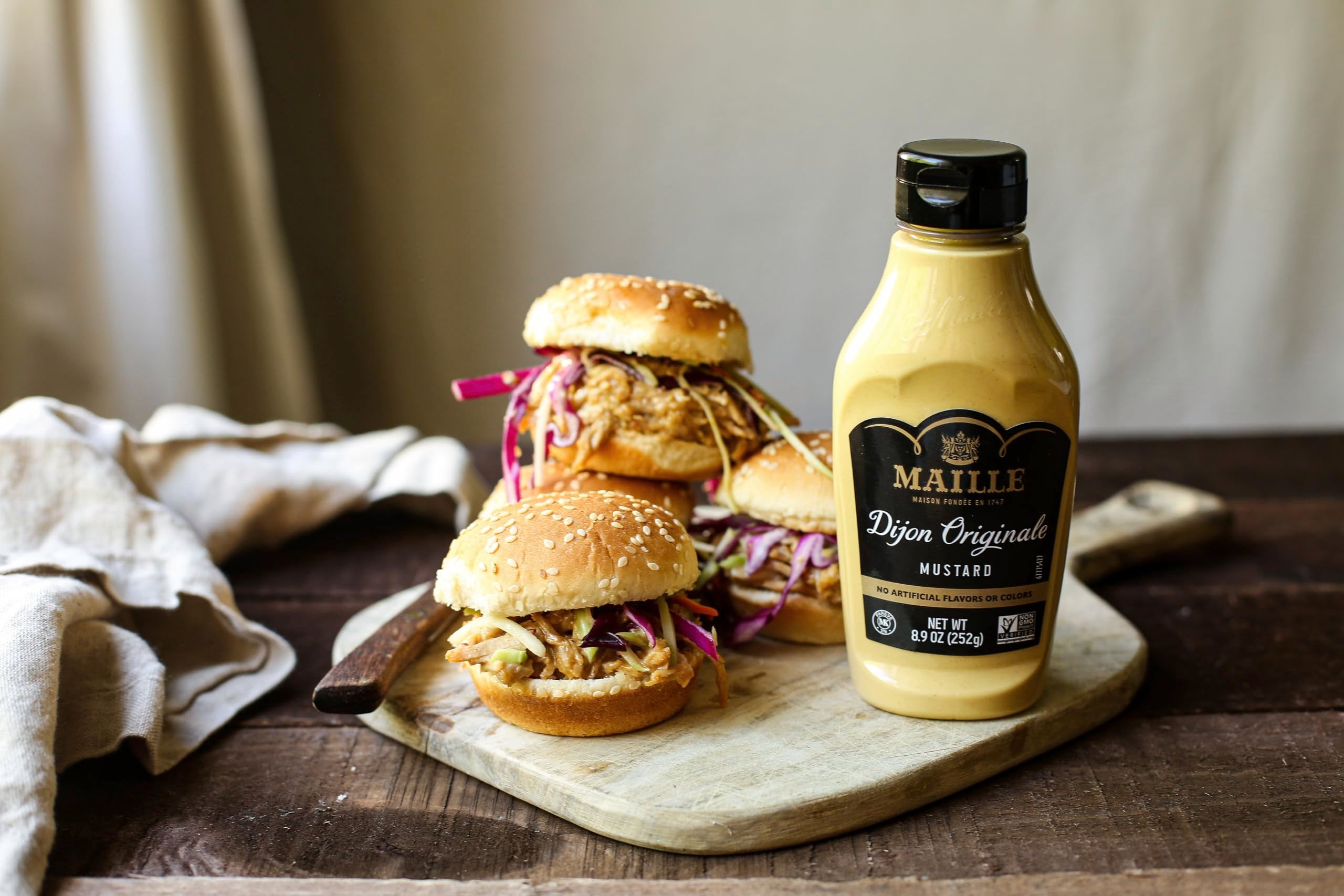 Maille Dijon Originale on a gourmet sandwich for extra zing.