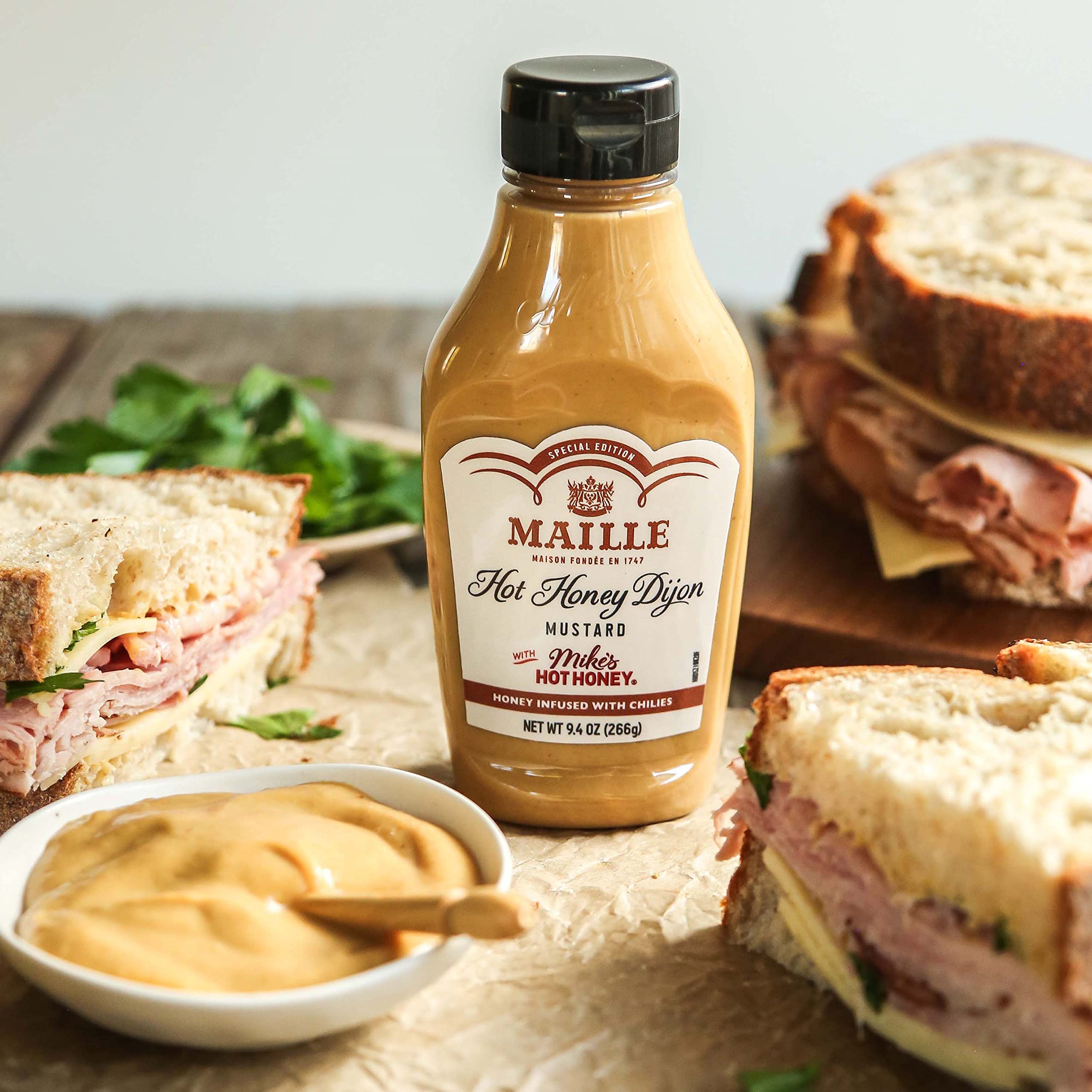 Sandwich topped with Maille x Mike's Hot Honey Dijon for tangy kick