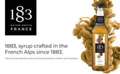 1883 MAISON ROUTIN hazelnut syrup being poured into a latte