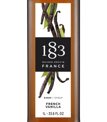 1883 Maison Routin vanilla syrup bottle pour, ideal for coffee and cocktails.