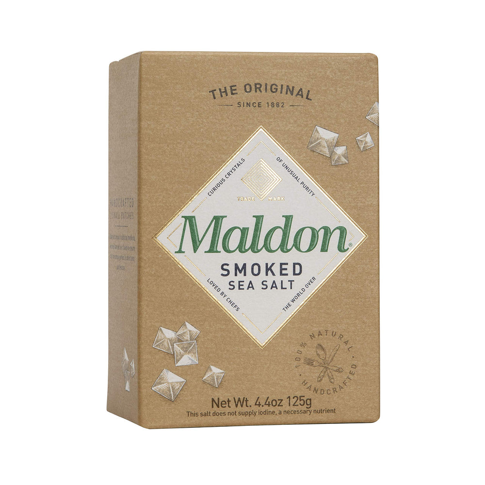 Maldon smoked sea salt flakes on chicken, subtly enhancing savoriness