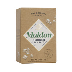 Maldon smoked sea salt flakes on chicken, subtly enhancing savoriness