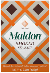 Maldon smoked sea salt flakes close-up; pyramid texture for seafood finishing.