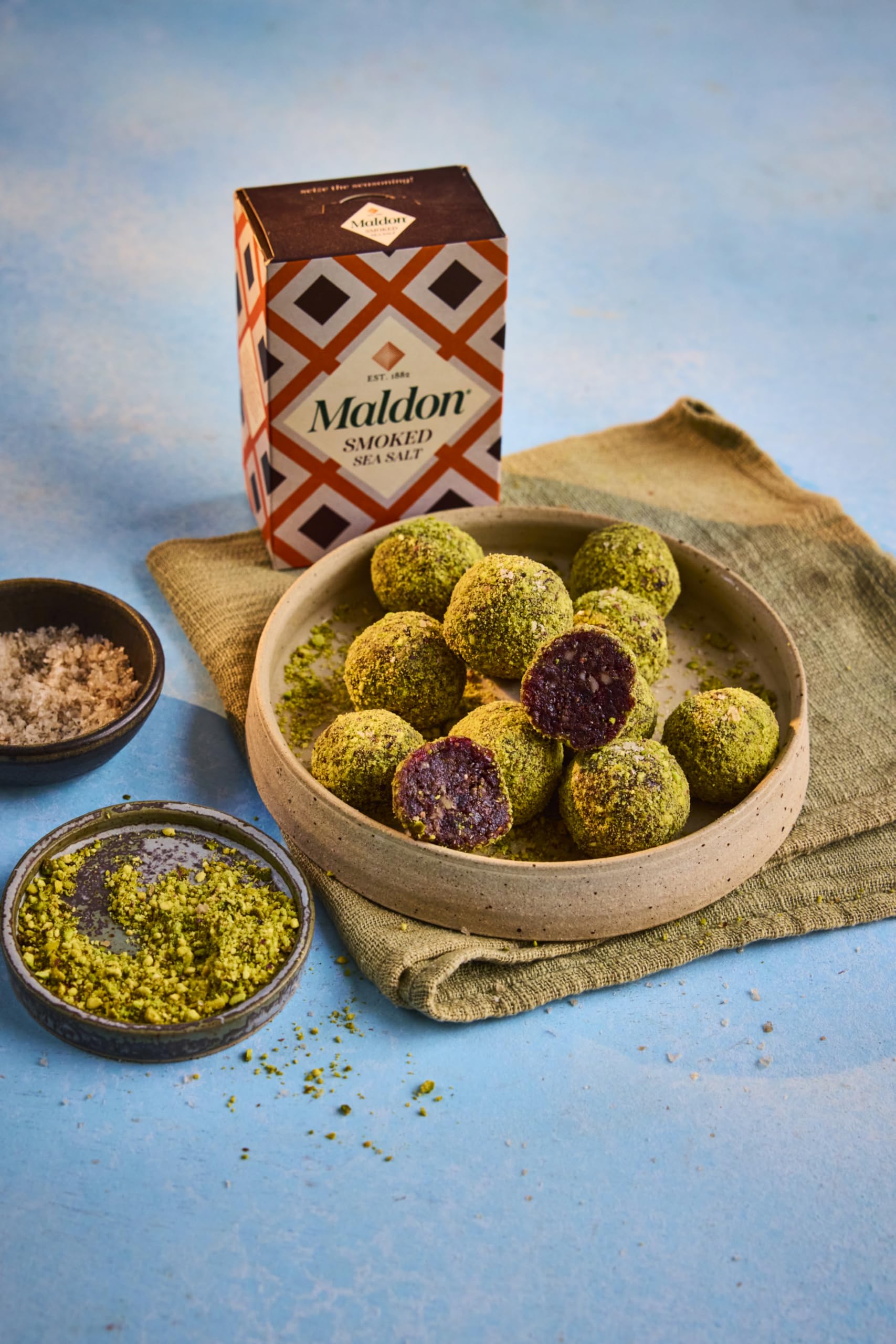 Maldon smoked sea salt flakes on steamed vegetables, balanced smoky touch