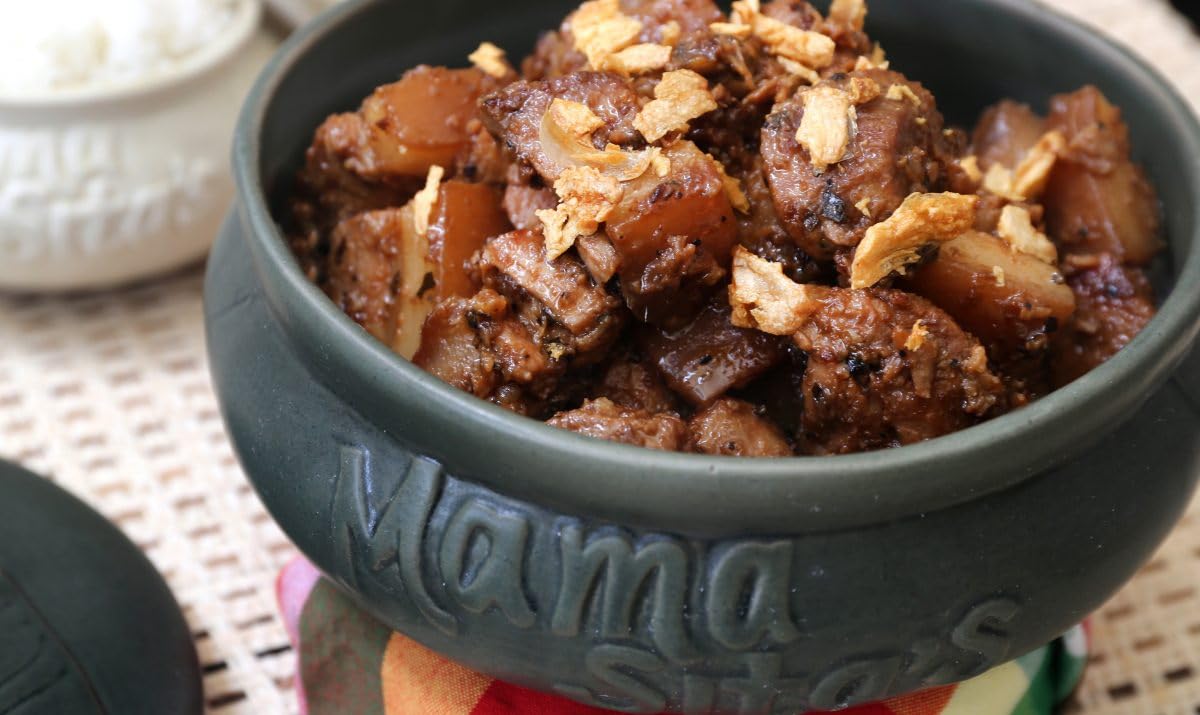 Mama Sita's Adobo prep bowl shows simmering sauce for a tasty dinner.