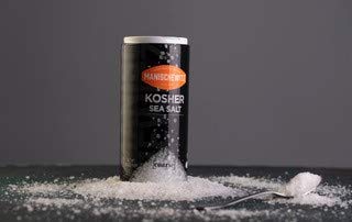 Manischewitz premium kosher salt crystals sprinkled over a dish to finish with flavor