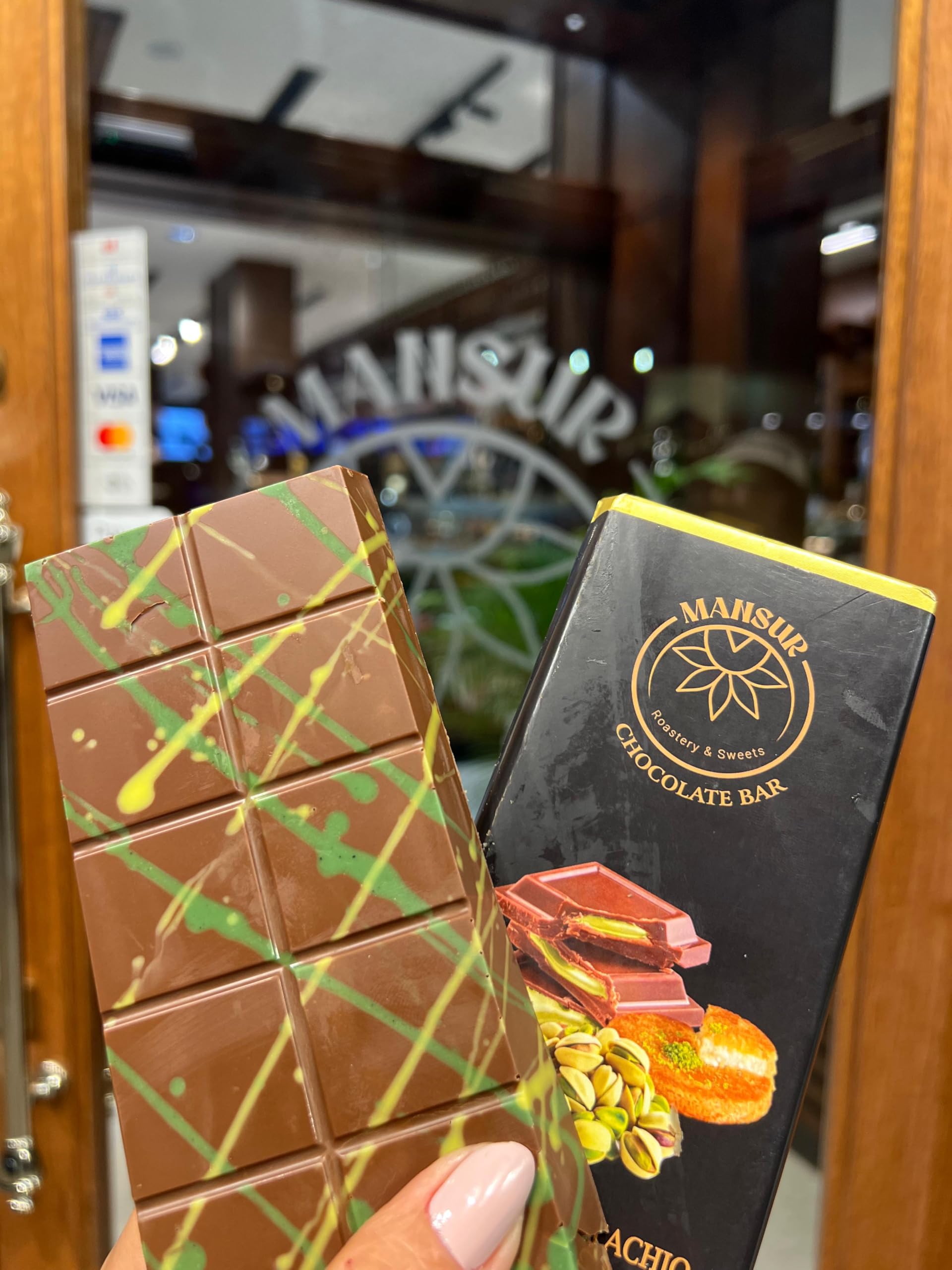 MANSUR Viral Dubai chocolate bar cross-section shows pistachios and milk chocolate for a crunchy bite.