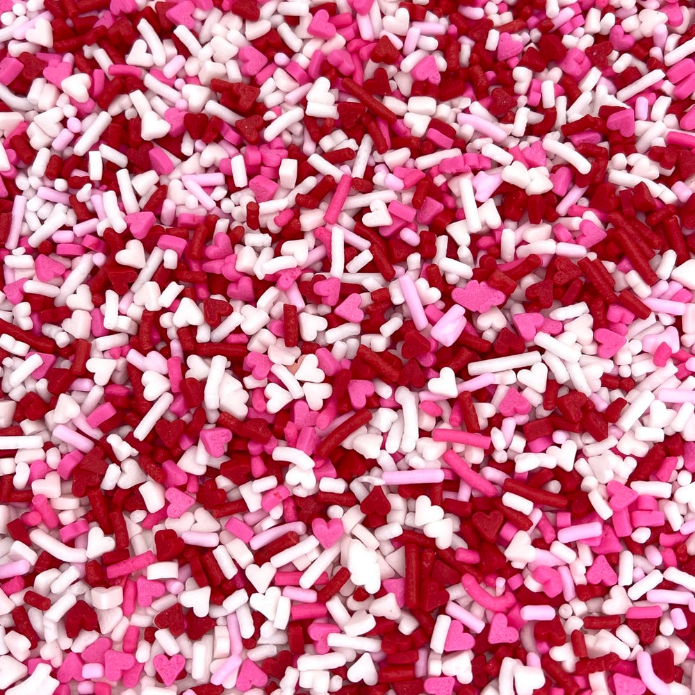 Manvscakes Valentine sprinkles on cakes and cookies adding color and sparkle.