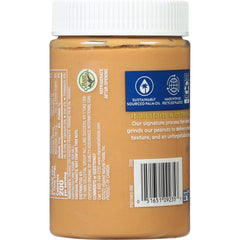 MaraNatha spoon dipping into creamy peanut butter highlights a smooth texture.