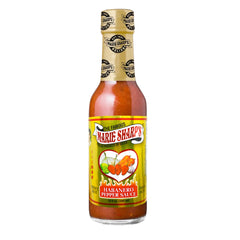Pouring Marie Sharp's Fiery Hot Habanero Sauce adds an extra hot kick.
