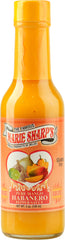 Marie Sharp's Mango Habanero bottle pour, showcasing tropical heat ready to elevate dishes