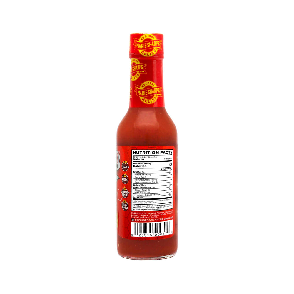 Pour shot of Marie Sharp's Red Hornet adding fiery depth to any dish