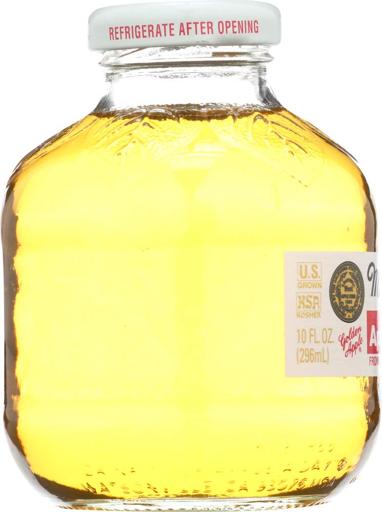 Martinelli's Apple Juice bottle pouring into a glass, ideal for everyday refreshment.